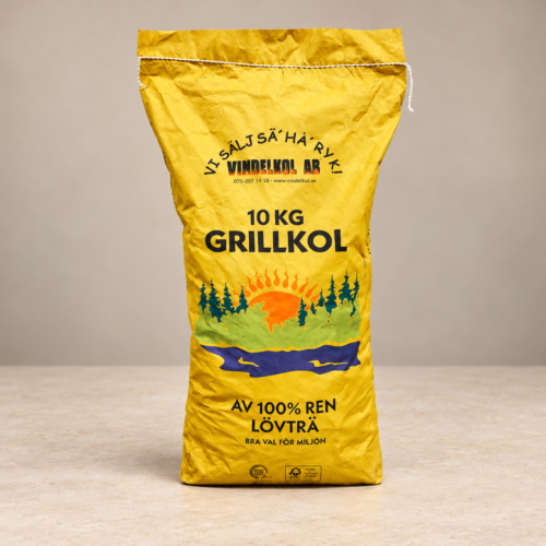 Vindelkol Grillkol 10 kg, gul säck på varm ljus stenbakgrund